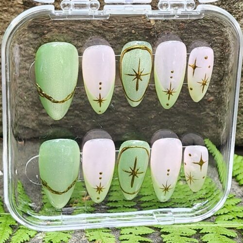 Close up of pink and green celestial pattern press-on nail kit in acrylic box