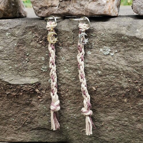 Two braided hemp keychains one with a gold moon charm and one with a silver moon charm
