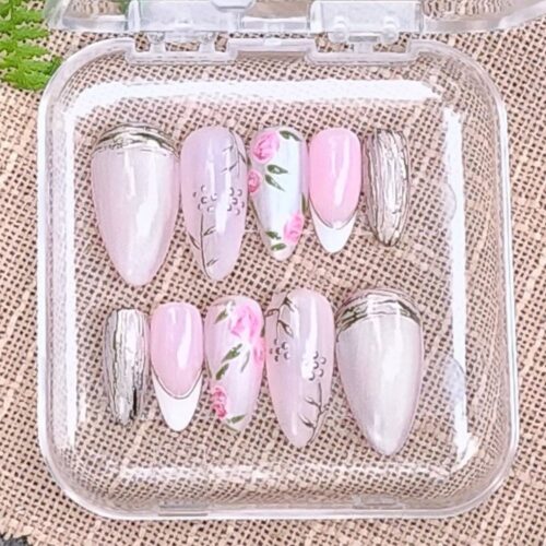 Close up of Pink rose pattern press-on nails in open acrylic box