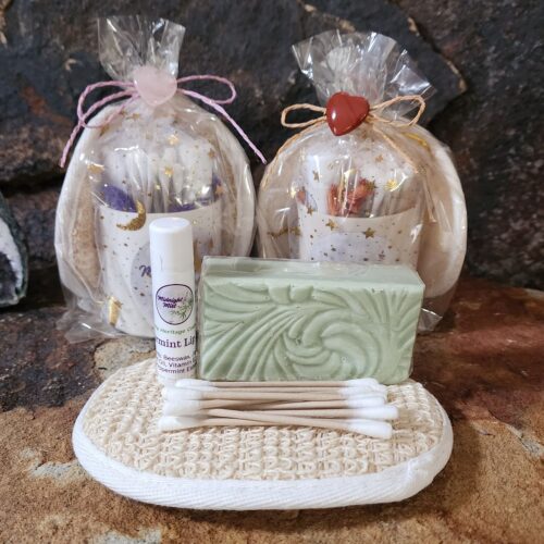 Flat lay of mini gift set with soap bar, lip balm, exfoliating pad, and hemp cotton swabs