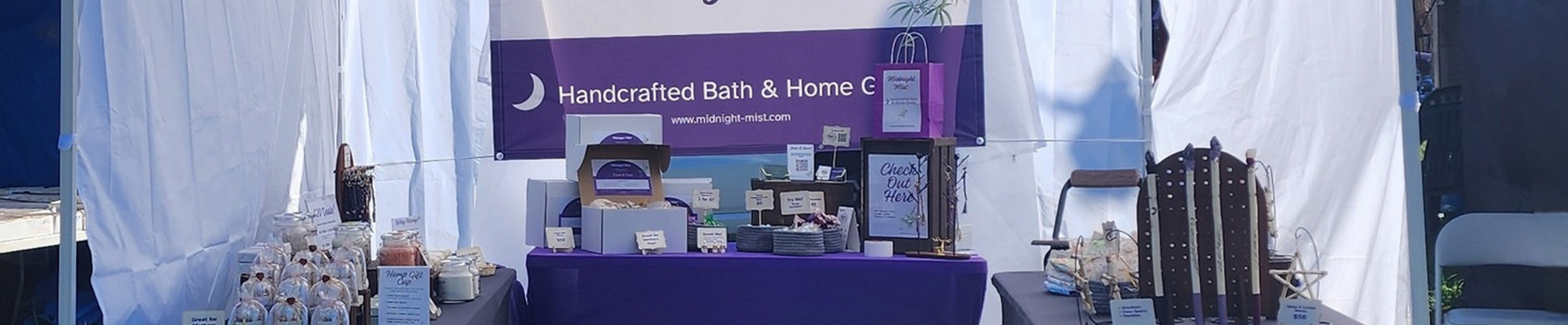 Close up of Midnight Mist booth at a festival