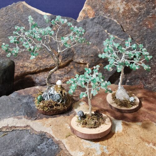 Handcrafted silver wire and green adventurine gemstone Tree of Life in Sapling (small), Woodland (medium), and Ancient (large) sizes on natural wood bases with natural moss and stone mushrooms.