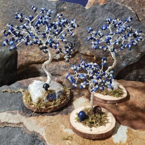Handcrafted silver wire and lapis lazuli gemstone Tree of Life in Sapling (small), Woodland (medium), and Ancient (large) sizes on natural wood bases with natural moss and stone mushrooms.